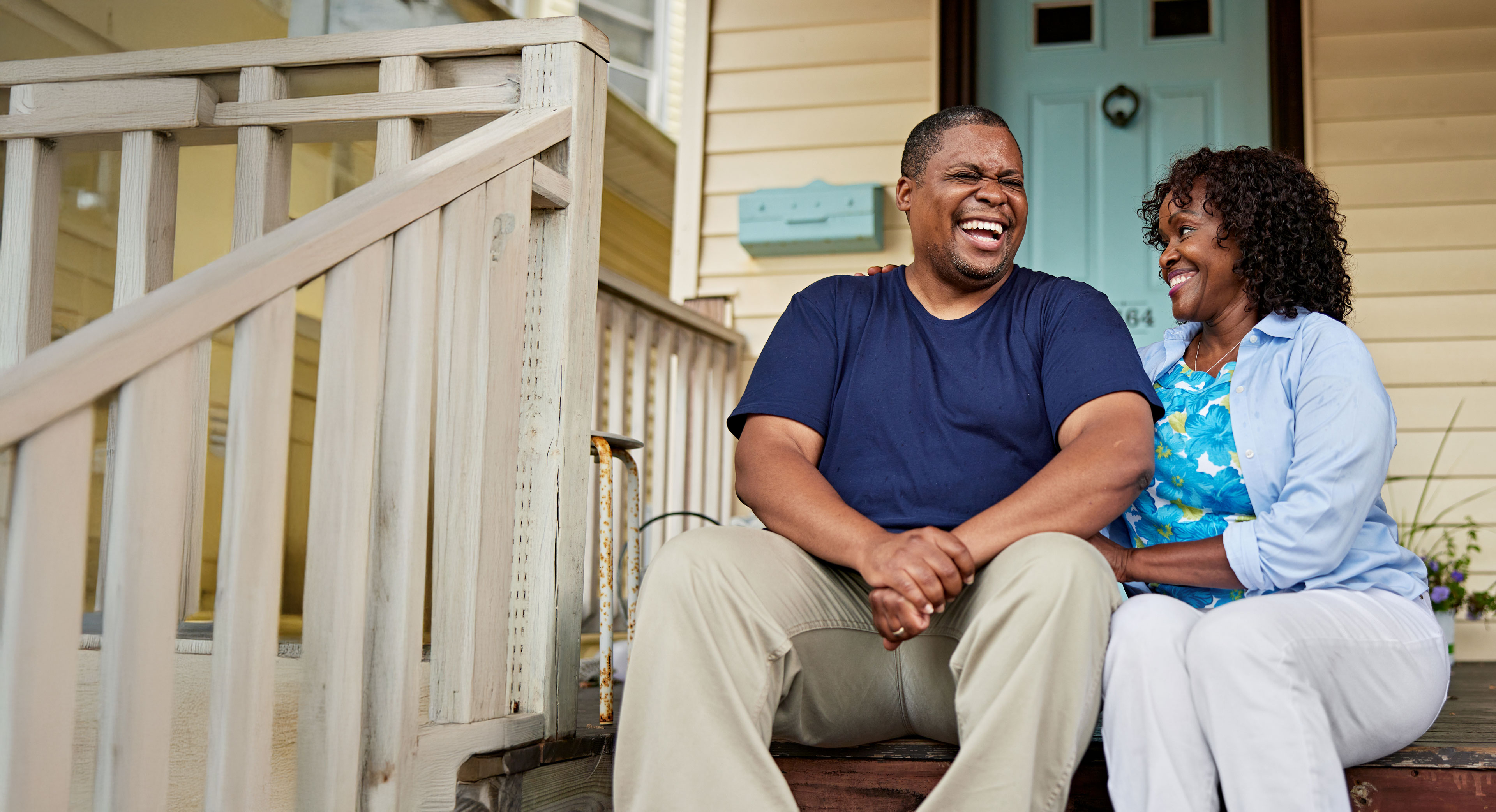 Couple laughing on porch