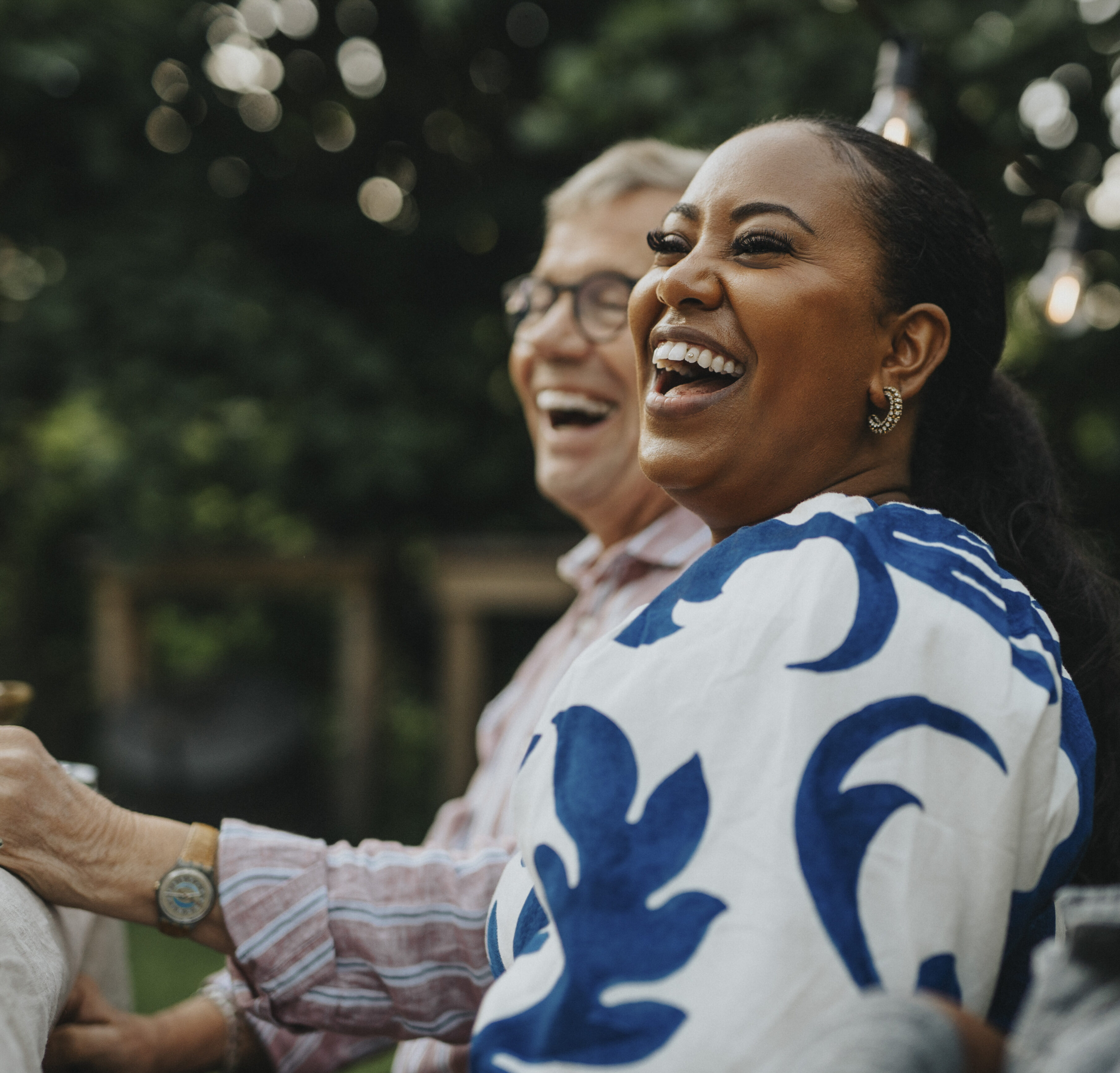 Cheerful woman having fun with male family members at social gathering